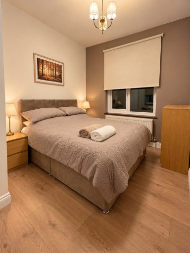 Double bedroom with bedside lamps and fresh linen at Cosy Retreats